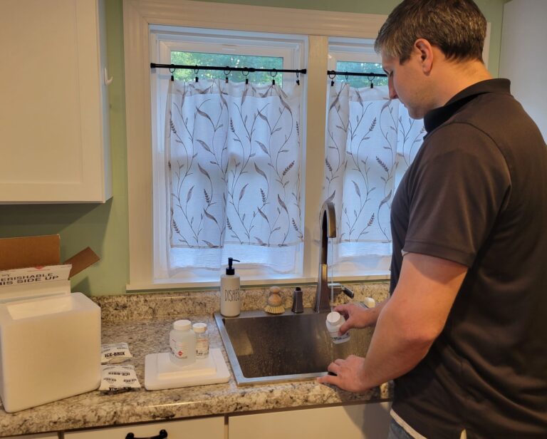 Justing (JD) Taggart collecting a water sample